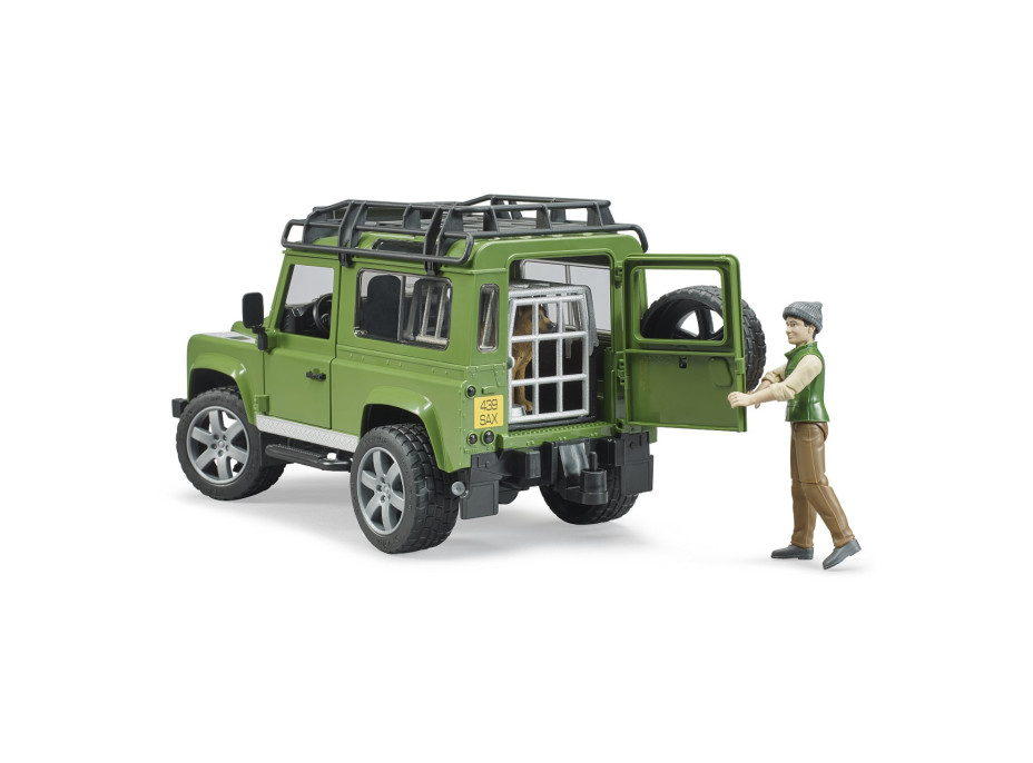 Bruder LAND ROVER DEFENDER s figúrkou poľovníka, psa a príslušenstvom